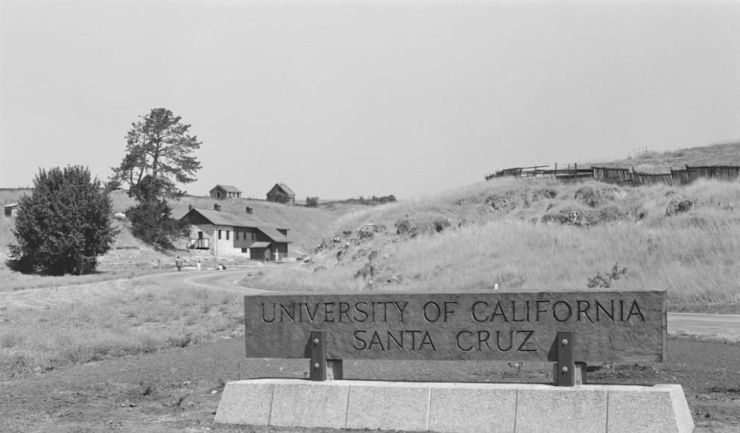 Campus entry sign with ranch buildings in the background